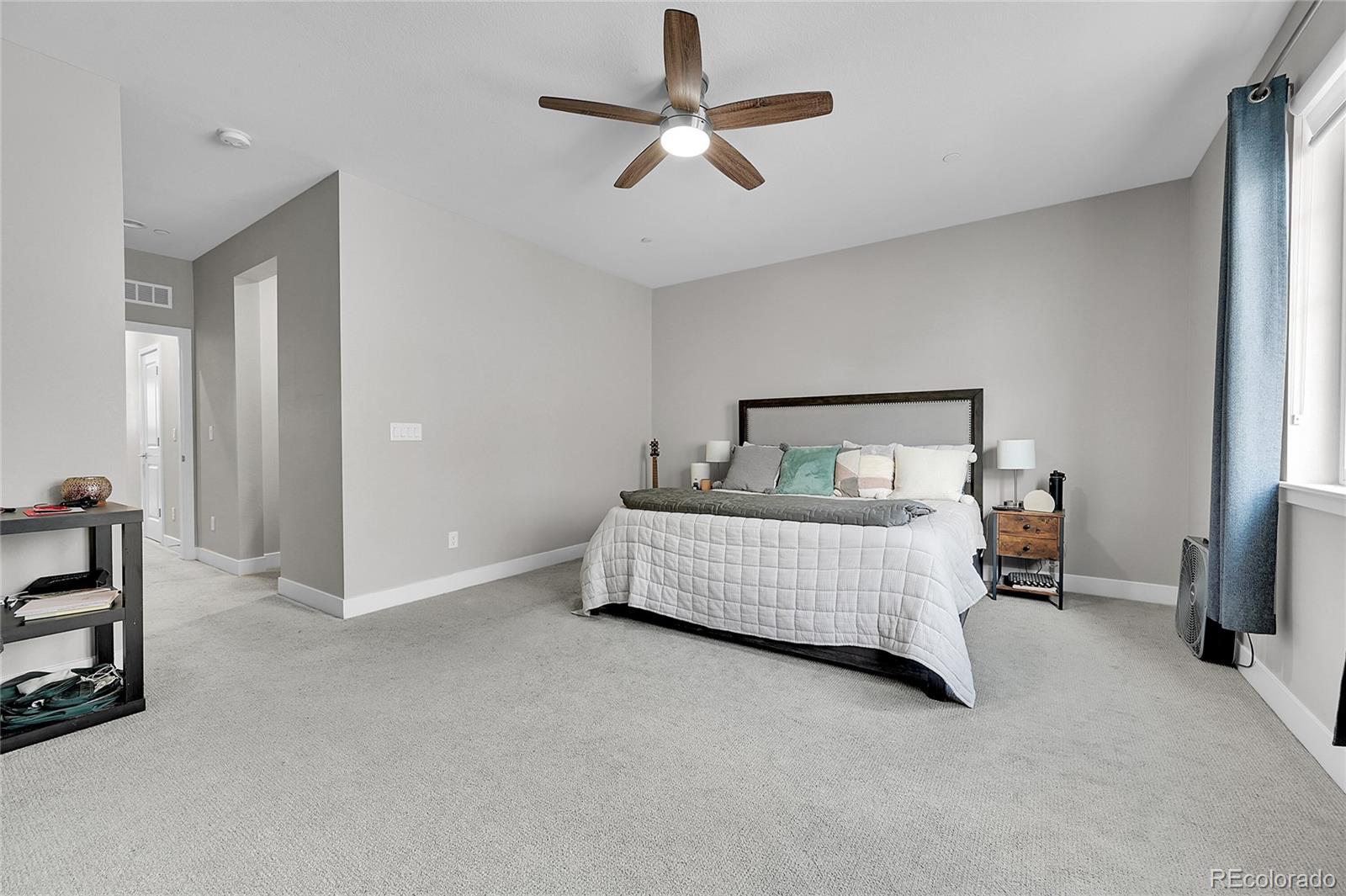 6218 West 28th Avenue Wheat Ridge, CO 80214 - Photo 11 of 16 a bedroom with a bed and a chandelier