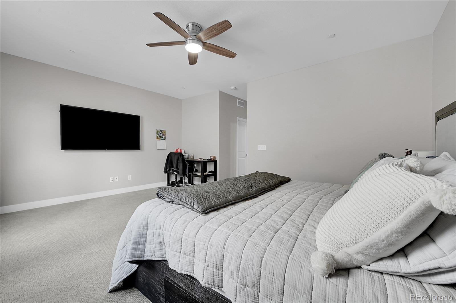 6218 West 28th Avenue Wheat Ridge, CO 80214 - Photo 12 of 16 a bedroom with a bed and a flat screen tv