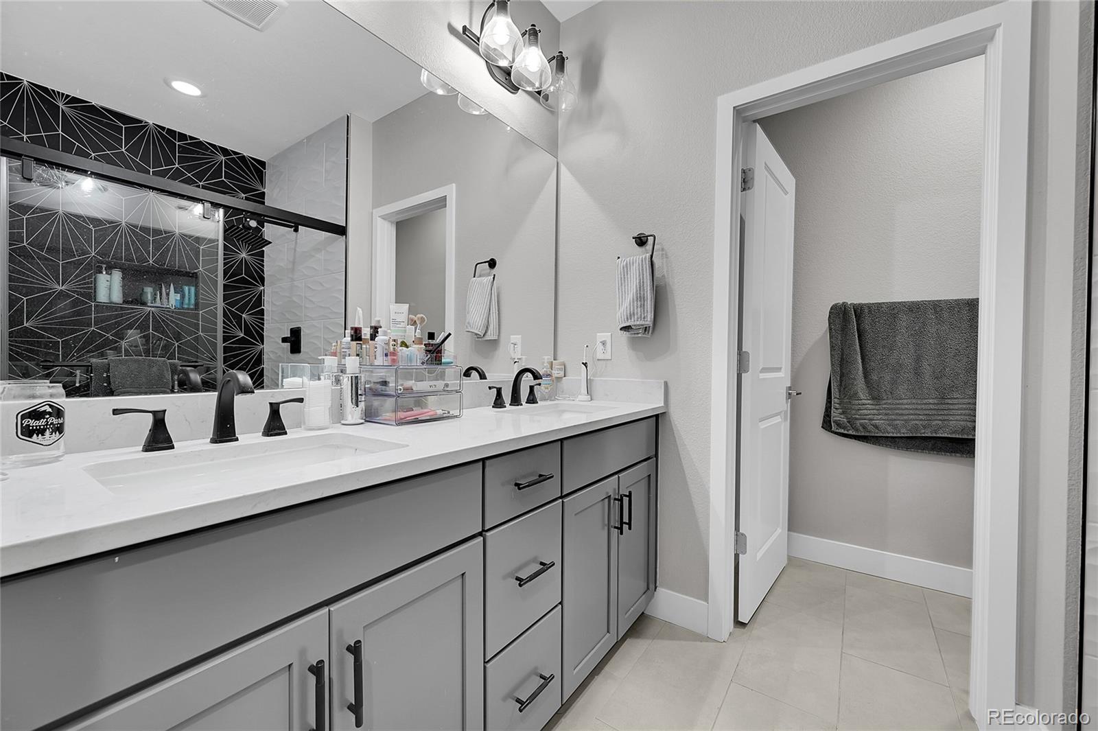 6218 West 28th Avenue Wheat Ridge, CO 80214 - Photo 13 of 16 a bathroom with a double vanity sink mirror and