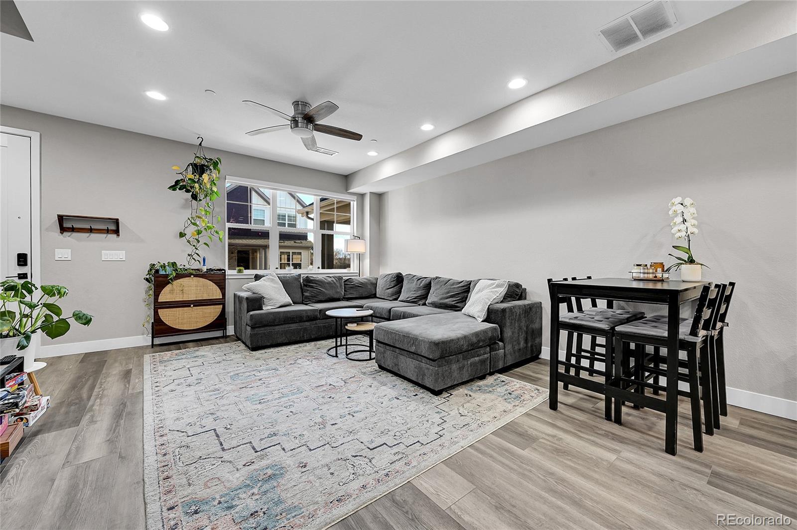 6218 West 28th Avenue Wheat Ridge, CO 80214 - Photo 4 of 16 a living room with furniture a chandelier and a table