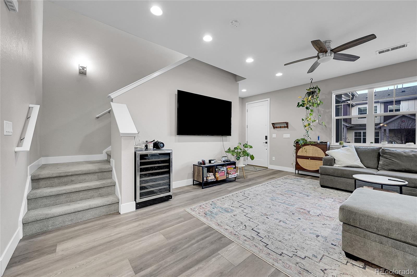 6218 West 28th Avenue Wheat Ridge, CO 80214 - Photo 5 of 16 a living room with furniture and a flat screen tv