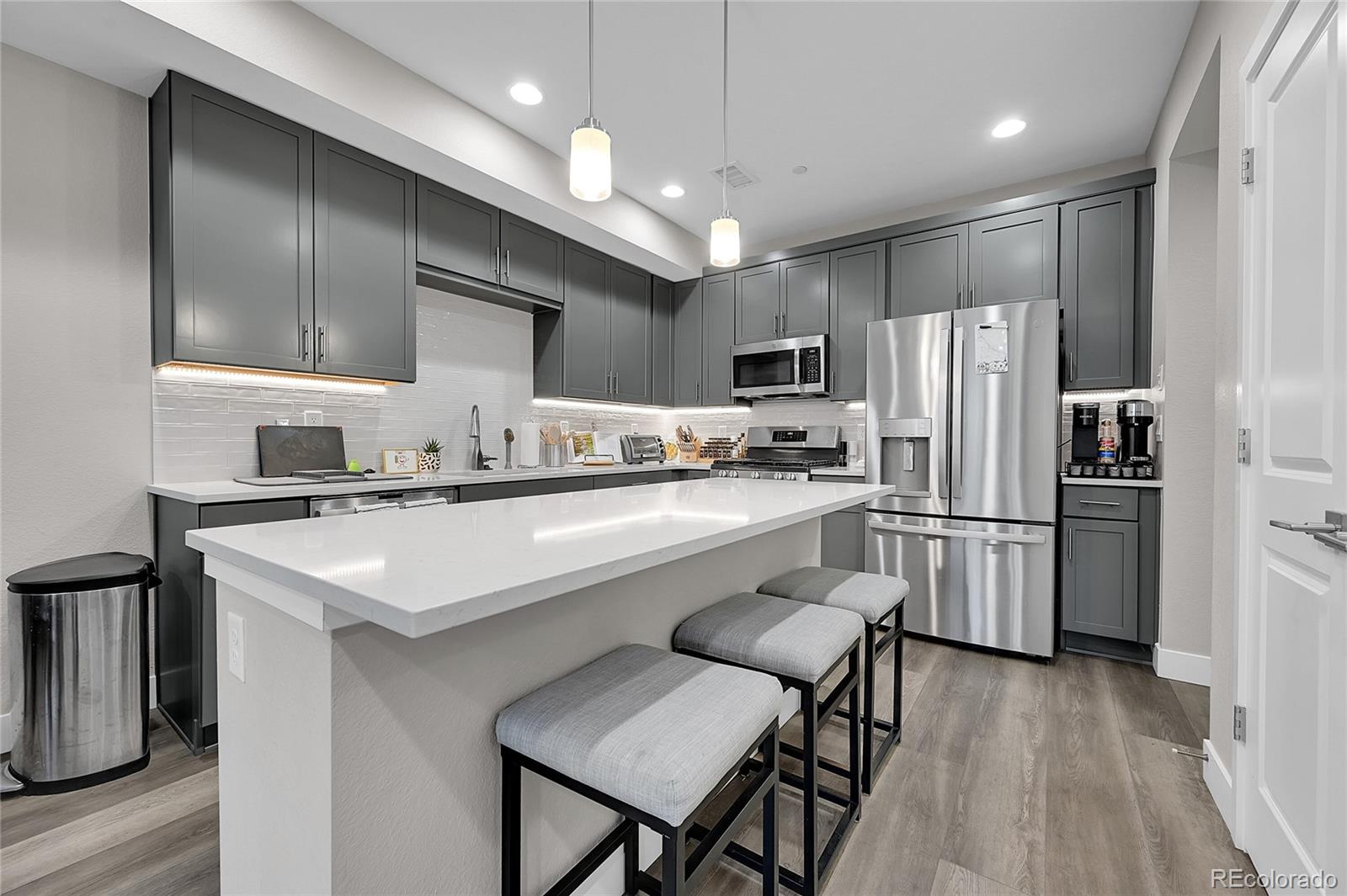 6218 West 28th Avenue Wheat Ridge, CO 80214 - Photo 6 of 16 a kitchen with refrigerator cabinets and wooden floor