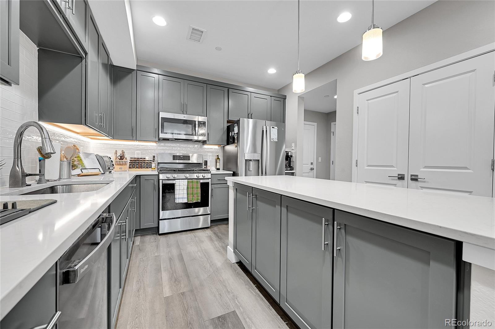 6218 West 28th Avenue Wheat Ridge, CO 80214 - Photo 7 of 16 a kitchen with stainless steel appliances a sink stove and refrigerator
