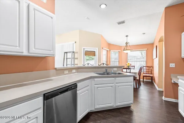a kitchen with a sink stove and cabinets