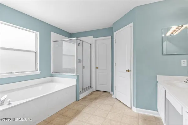 a bathroom with a bathtub and a shower