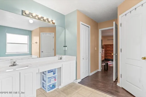 a en suite bathroom with a sink double vanity and a mirror