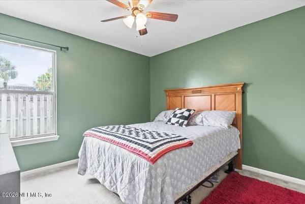 a bedroom with a bed and window