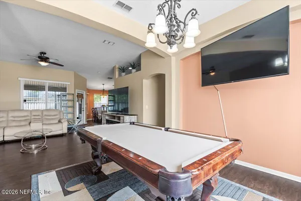 a room with pool table and windows