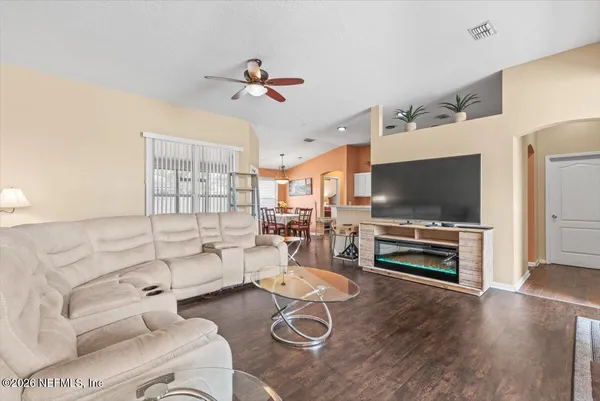 a living room with furniture and a flat screen tv