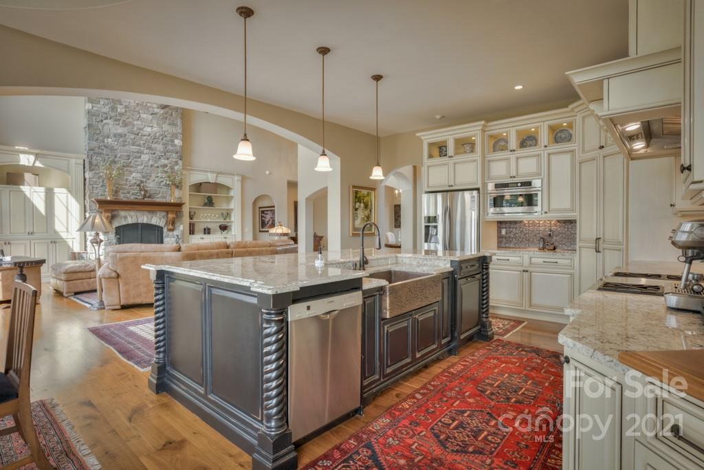 874-a R A R Thompson Road, Unit 24 Mill Spring, NC 28756 - Photo 14 of 47 a large kitchen with stainless steel appliances granite countertop a stove and a sink