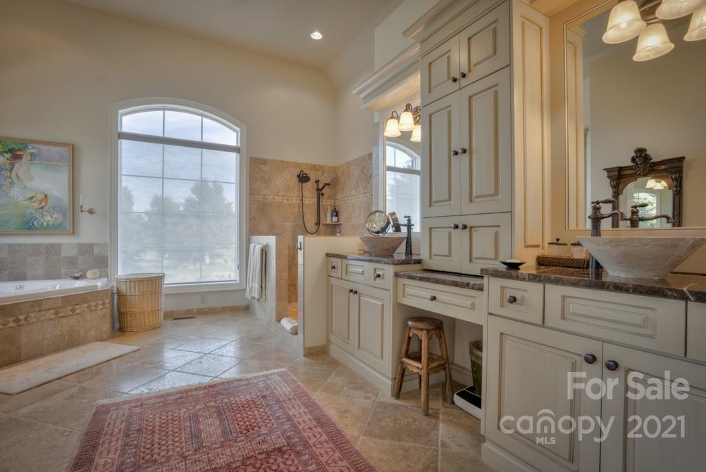 874-a R A R Thompson Road, Unit 24 Mill Spring, NC 28756 - Photo 19 of 47 a spacious bathroom with a double vanity sink a mirror and a bathtub