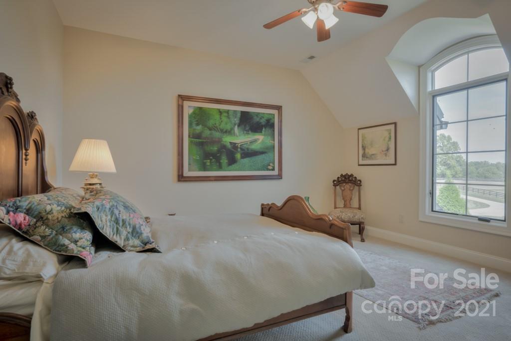 874-a R A R Thompson Road, Unit 24 Mill Spring, NC 28756 - Photo 30 of 47 a bedroom with a bed and a chandelier