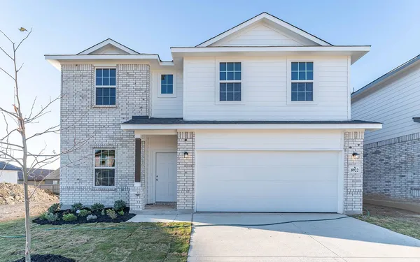 a front view of a house with garage