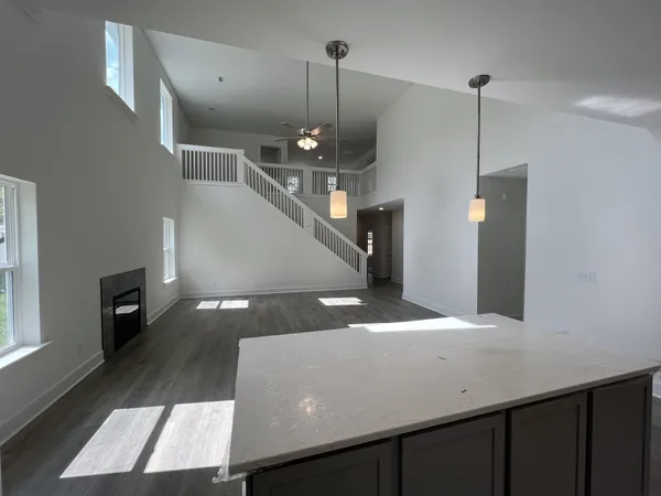 a kitchen with a sink a refrigerator and wooden floor