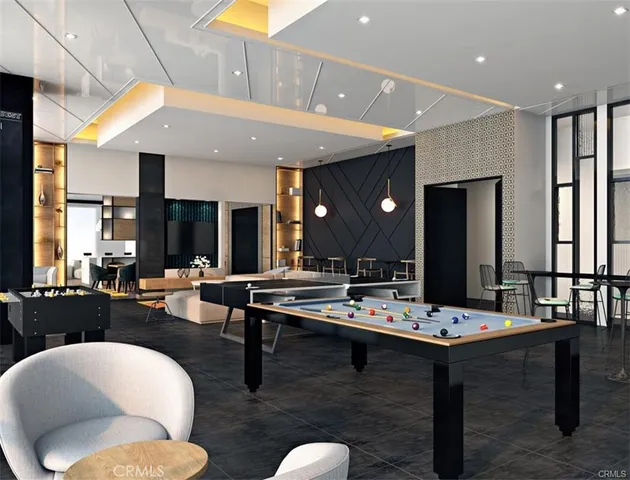 a dining hall with couches a flat tv screen and couches