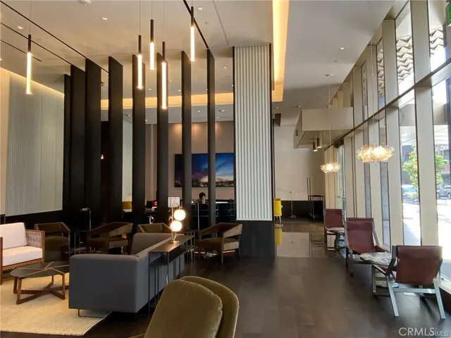 a living room with furniture and large windows