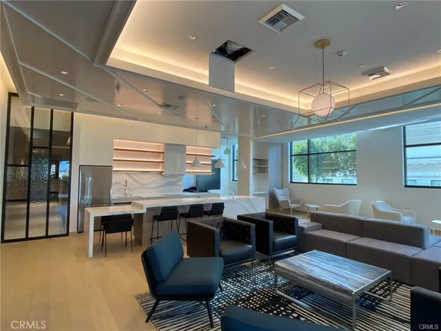 a living room with furniture a window and kitchen view