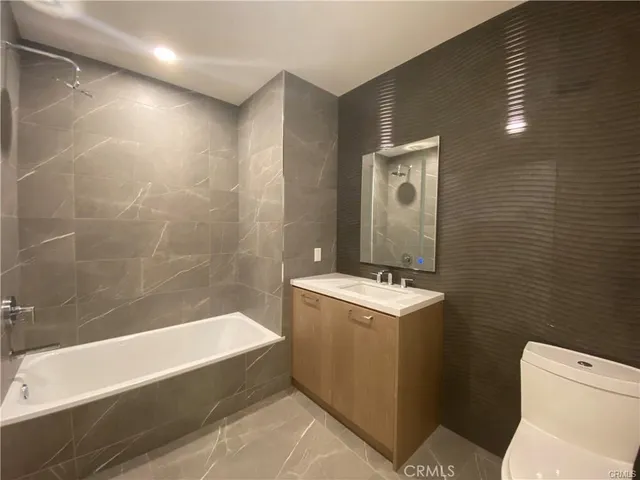a bathroom with a sink a toilet and bathtub