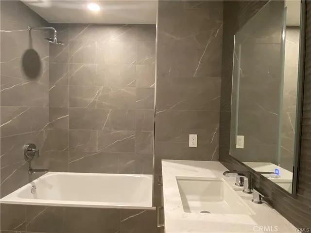 a bathroom with a bathtub and a shower