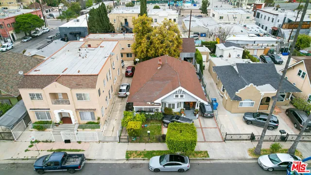 an aerial view of residential houses with outdoor space