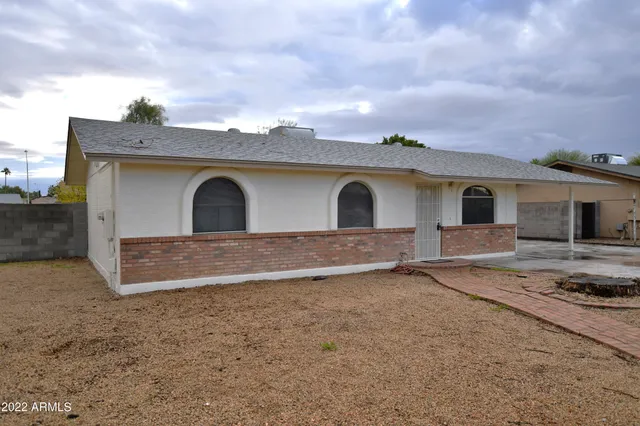 a view of a house with a wooden fence