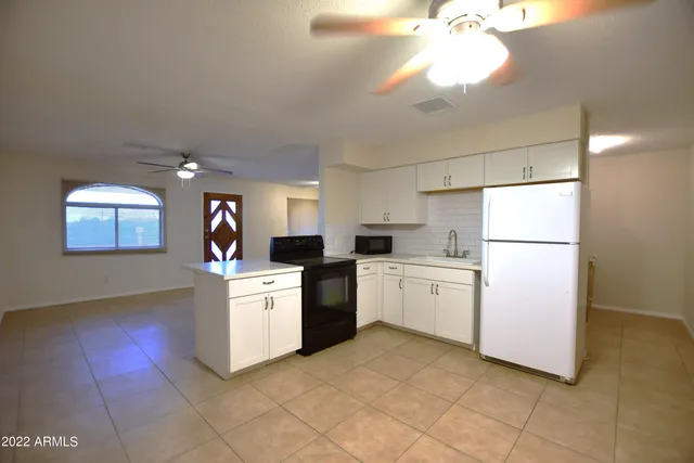 a kitchen with a white cabinets and white appliances