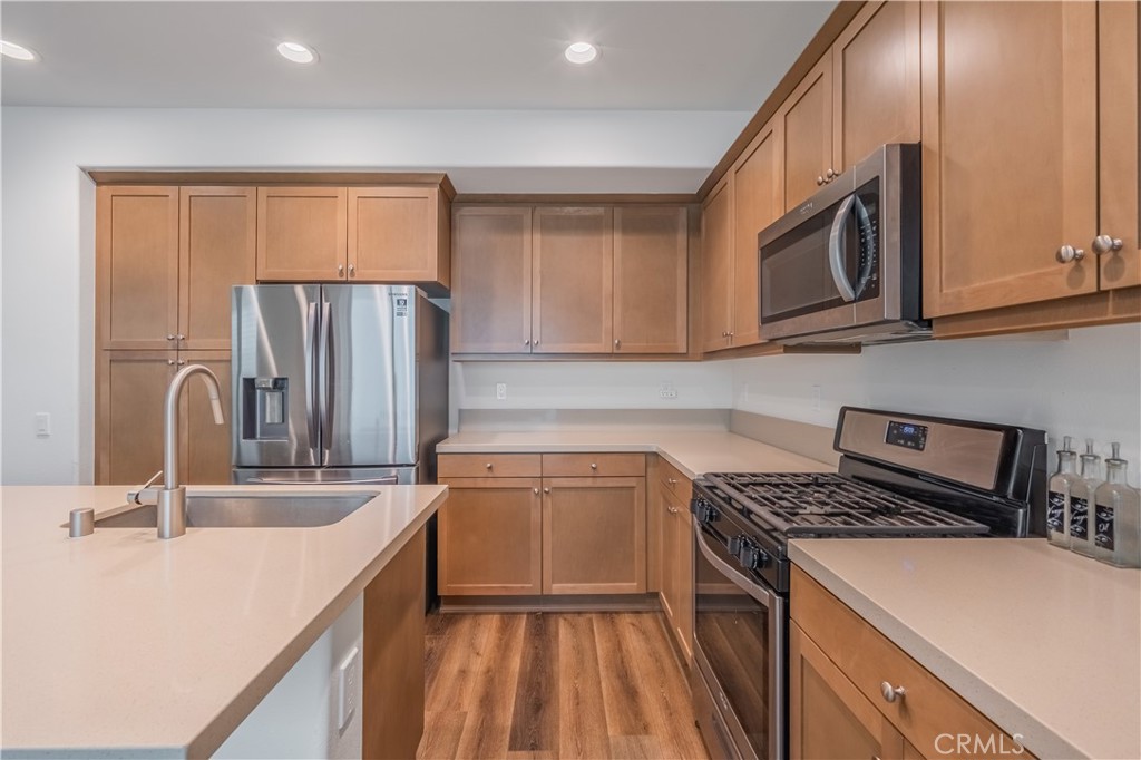 9513 Retreat Place Rancho Cucamonga, CA 91730 - Photo 11 of 49 a kitchen with a sink stove and refrigerator