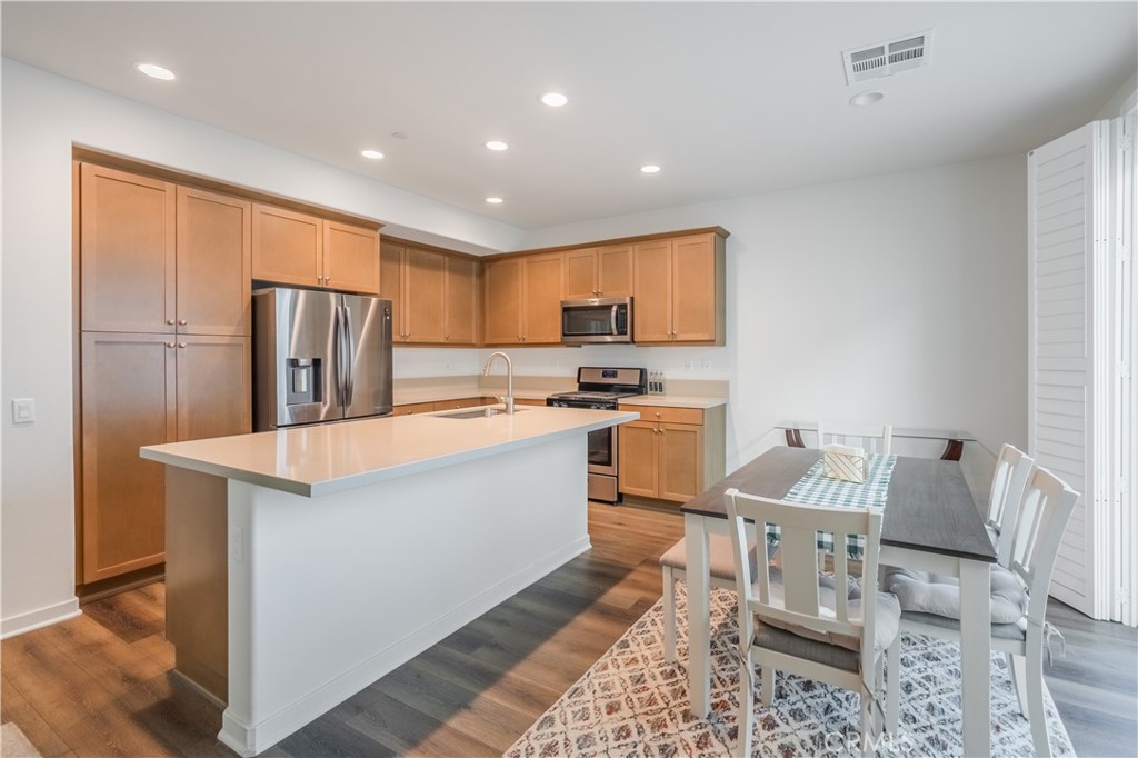 9513 Retreat Place Rancho Cucamonga, CA 91730 - Photo 13 of 49 a kitchen with sink refrigerator and microwave