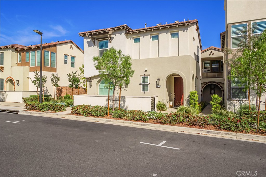 9513 Retreat Place Rancho Cucamonga, CA 91730 - Photo 2 of 49 a front view of a house with a garden