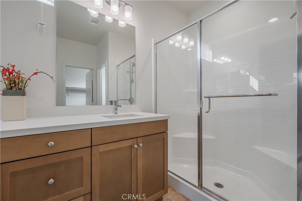 9513 Retreat Place Rancho Cucamonga, CA 91730 - Photo 22 of 49 a bathroom with a shower sink vanity and mirror