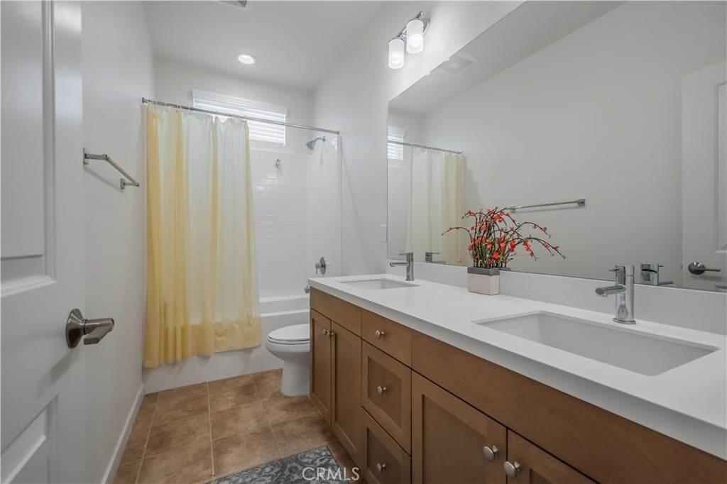 9513 Retreat Place Rancho Cucamonga, CA 91730 - Photo 26 of 49 a bathroom with a double vanity sink toilet mirror and shower