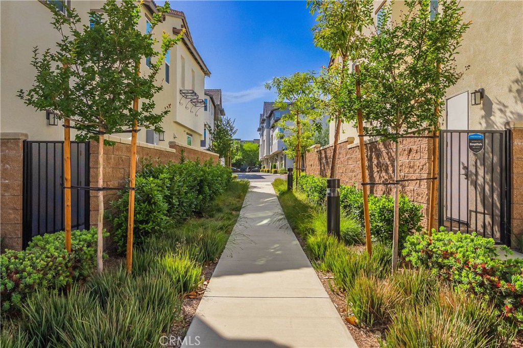 9513 Retreat Place Rancho Cucamonga, CA 91730 - Photo 36 of 49 a view of a pathway with house on both side
