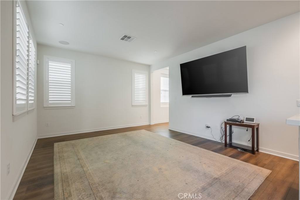 9513 Retreat Place Rancho Cucamonga, CA 91730 - Photo 8 of 49 a living room with flat screen tv and a window