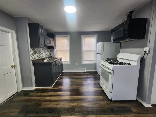 a view of kitchen with sink and refrigerator