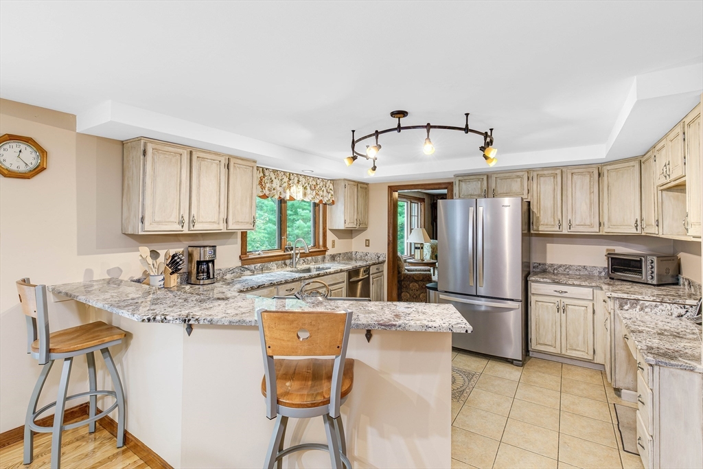 156 Newbury Road Rowley, MA 01969 - Photo 8 of 41 a kitchen with stainless steel appliances granite countertop a stove refrigerator sink and cabinets