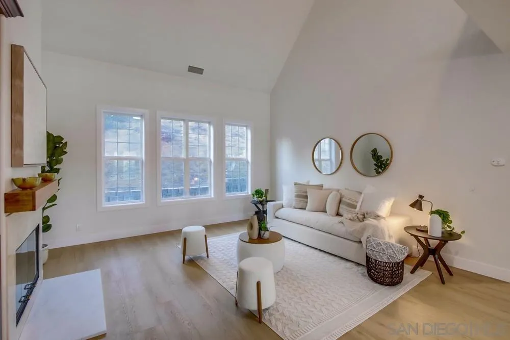 2543 Daisy Lane Fallbrook, CA 92028 - Photo 34 of 74 a living room with couches a coffee table and a chandelier with wooden floor