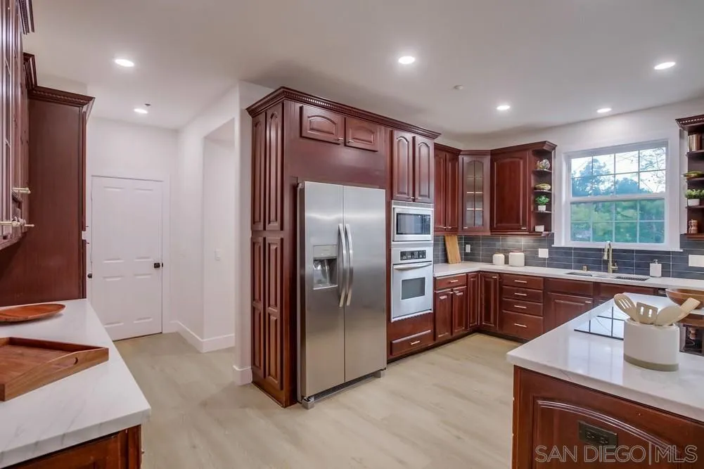 2543 Daisy Lane Fallbrook, CA 92028 - Photo 39 of 74 a kitchen with stainless steel appliances granite countertop a refrigerator a sink and a stove