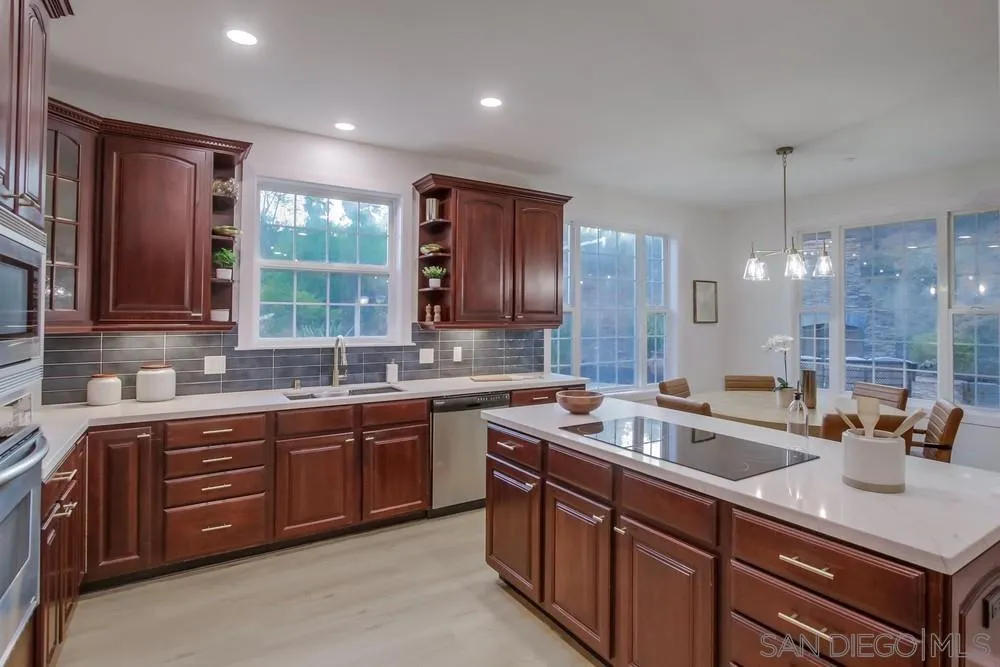 2543 Daisy Lane Fallbrook, CA 92028 - Photo 40 of 74 a kitchen with lots of counter top space sink and a mirror