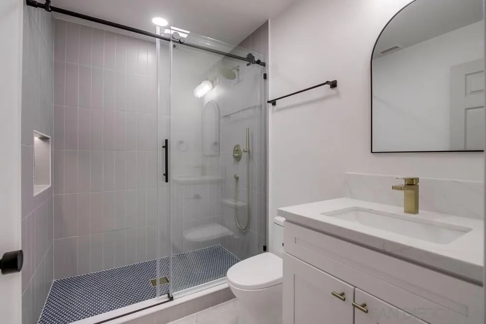 2543 Daisy Lane Fallbrook, CA 92028 - Photo 49 of 74 a bathroom with a shower sink vanity mirror and toilet
