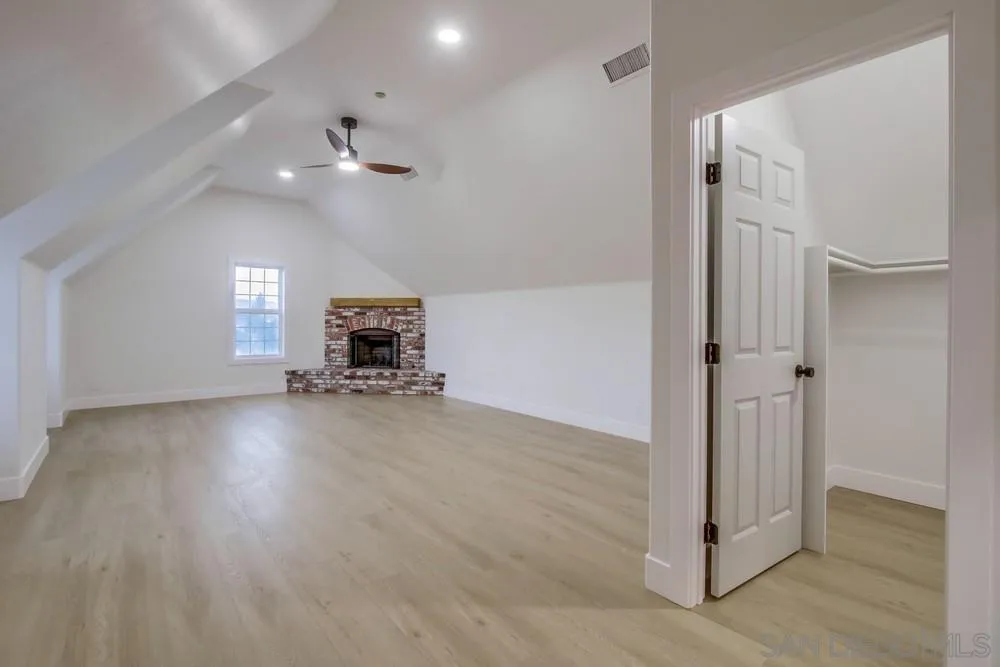 2543 Daisy Lane Fallbrook, CA 92028 - Photo 50 of 74 an empty room with wooden floor cabinet and windows