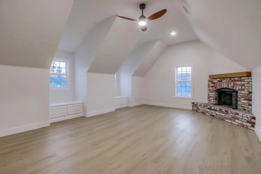 2543 Daisy Lane Fallbrook, CA 92028 - Photo 51 of 74 an empty room with windows and fireplace