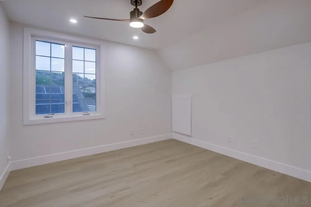 2543 Daisy Lane Fallbrook, CA 92028 - Photo 54 of 74 an empty room with wooden floor fan and windows