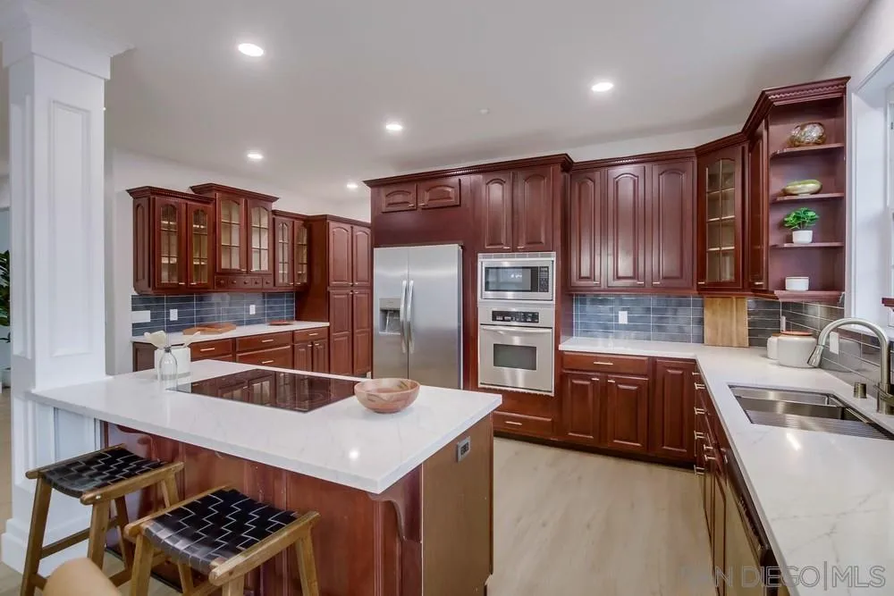 2543 Daisy Lane Fallbrook, CA 92028 - Photo 8 of 74 a kitchen with stainless steel appliances a sink stove and refrigerator