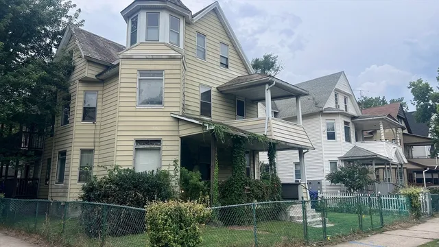 a front view of a house with plants