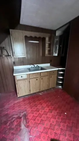 a view of kitchen with granite countertop a sink and a stove