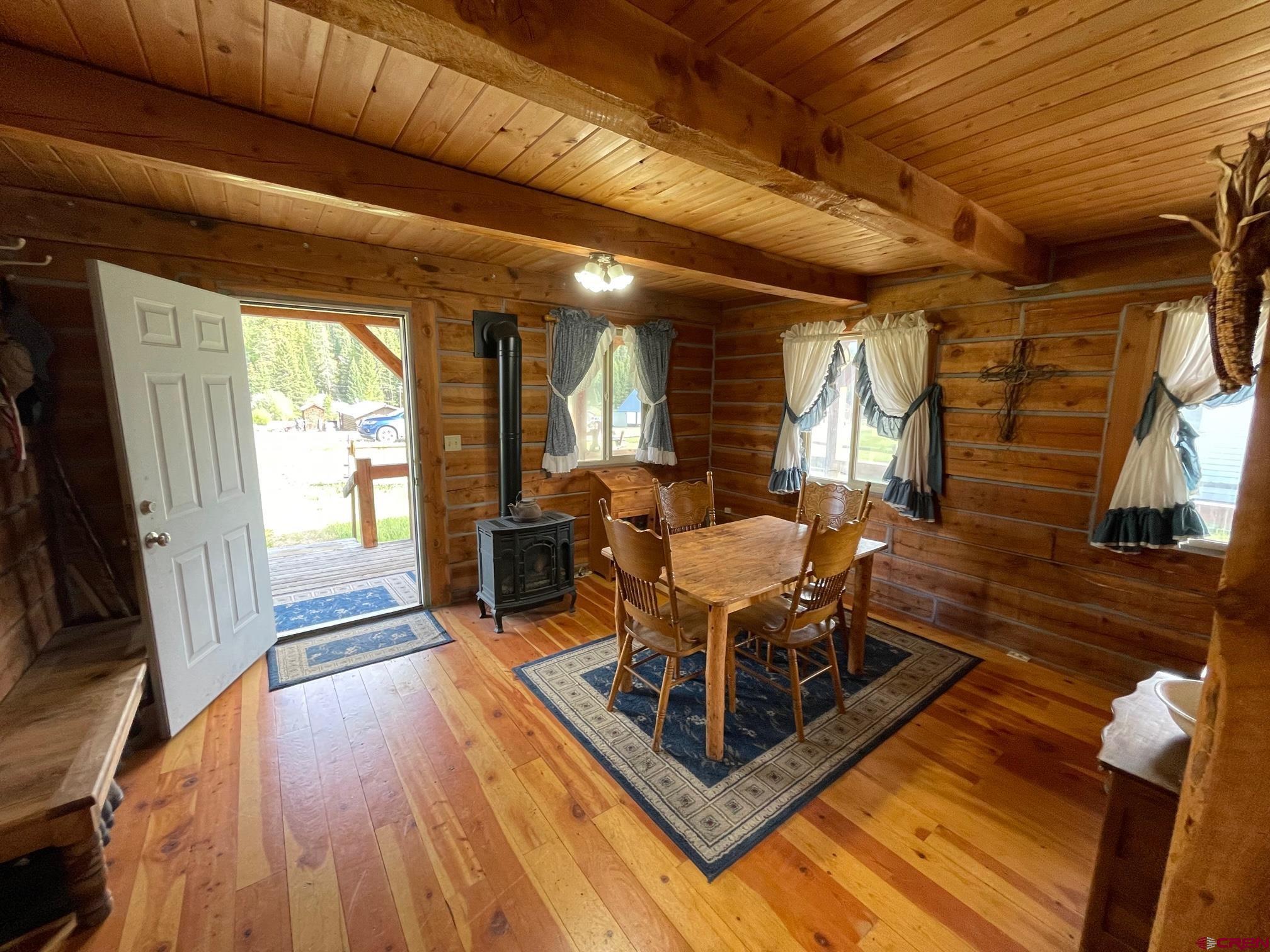417 State Street Pitkin, CO 81241 - Photo 6 of 23 a living room with furniture a wooden floor and next to a window