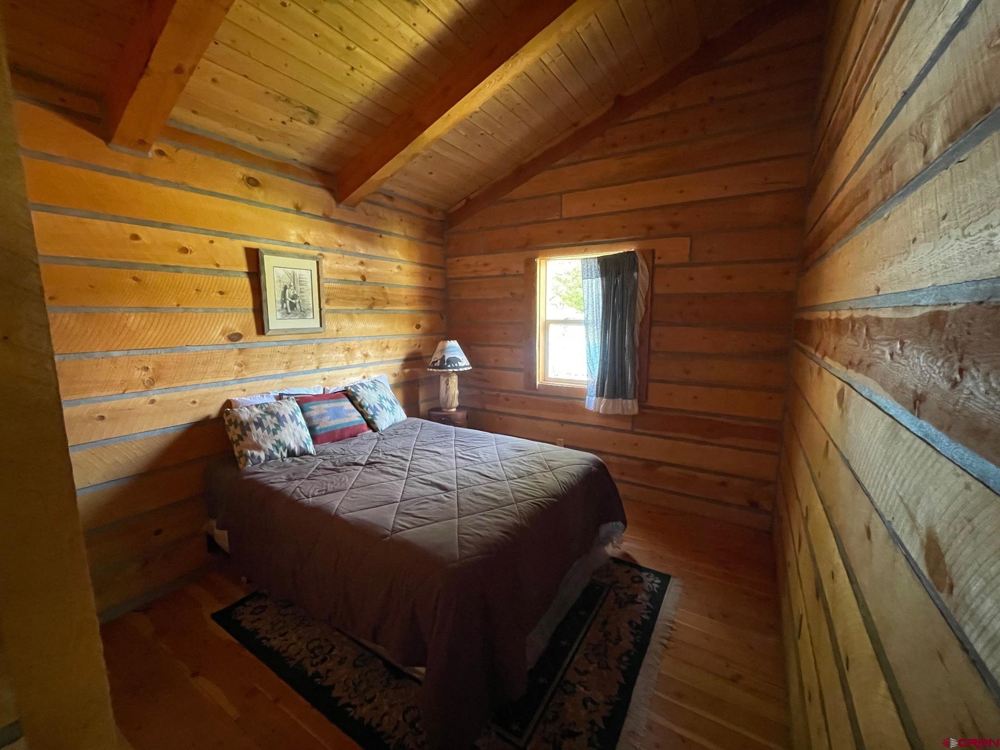 417 State Street Pitkin, CO 81241 - Photo 10 of 23 a bedroom with a bed and wooden floor