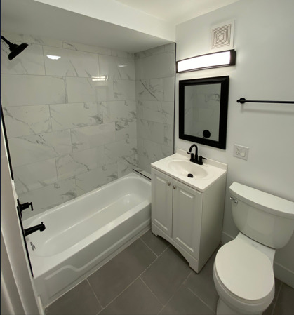 2203 South Ridgeway Avenue Chicago, IL 60623 - Photo 6 of 9 a bathroom with a toilet sink and mirror