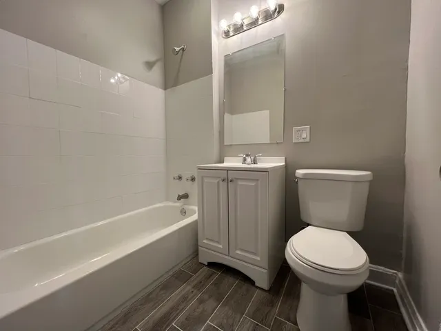 a bathroom with a toilet a sink and bathtub