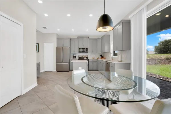 a kitchen with stainless steel appliances granite countertop a sink a refrigerator and a stove